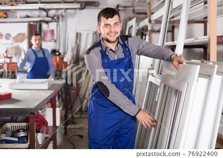 Glad young workers with different PVC windows 76922400