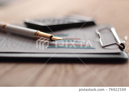 close up. pen with a gold NIB on blurred background office Desk 76922589