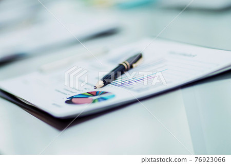 pen and financial documents on the table of the businessman pen and financial documents on the table of the businessman 76923066