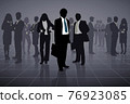 Outline of a group of business people on a black background 76923085
