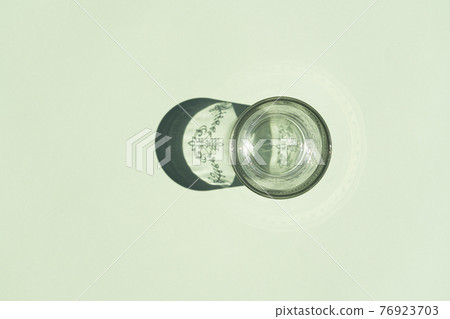 glass with a hard shadow on a colored background glass with a hard shadow on a colored background 76923703