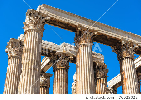 Ancient Temple of Olympian Zeus, Athens, Greece. Corinthian columns on blue sky background 76925025
