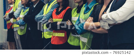 Large group of factory worker standing together in warehouse or storehouse Large group of factory worker standing together in warehouse or storehouse 76925142