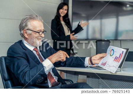 Businesswoman presents senior executive manager. Businesswoman presents senior executive manager. 76925143