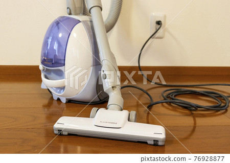 Vacuum cleaner connected to a wall outlet 76928877