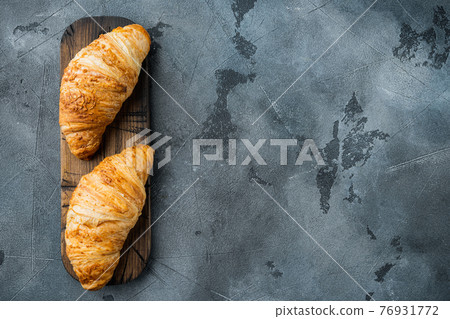 Crispy fresh croissants, on gray stone background, top view flat lay, with copy space for text 76931772
