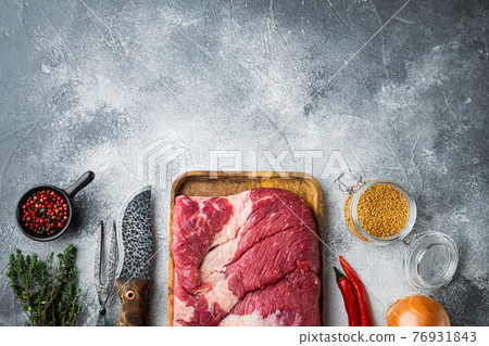 Packer brisket, raw beef brisket meat,with ingredients for smoking making barbecue, pastrami, cure, on gray stone background, top view flat lay, with copy space for text 76931843