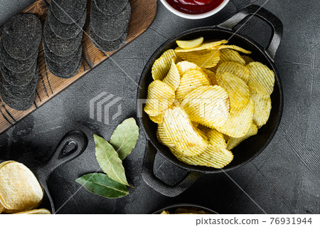 Crispy potato chips, with dipping sauces , on gray stone background, top view flat lay 76931944