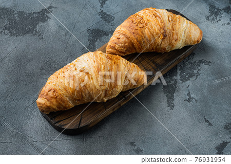 Tasty buttery croissants, on gray stone background, with copy space for text 76931954