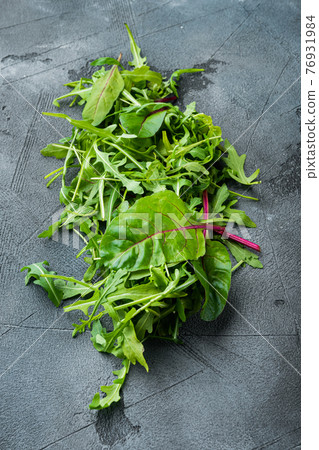 Arugula, Chard herbs mix , on gray stone background Arugula, Chard herbs mix , on gray stone background 76931984