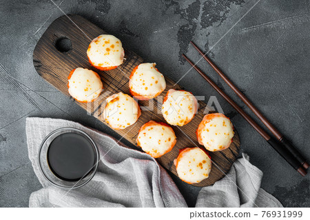 Japanese sushi rolls named Baked Ebi with wasabi and salmon fish, on gray stone background, top view flat lay , with copyspace and space for text 76931999