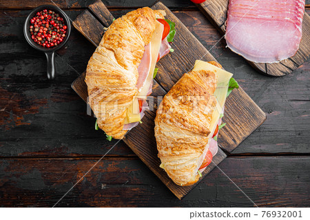 Classic BLT croissant sandwiches, with herbs and ingredients, on old dark wooden table background, top view flat lay Classic BLT croissant sandwiches, with herbs and ingredients, on old dark wooden table background, top view flat lay 76932001