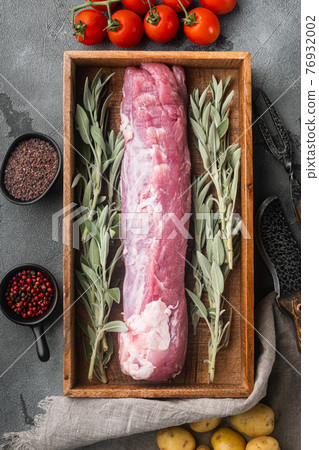 Raw pork loin with ingredients and herbs for baking, sage, potatoe, in wooden box, on gray stone background, top view flat lay Raw pork loin with ingredients and herbs for baking, sage, potatoe, in wooden box, on gray stone background, top view flat lay 76932002