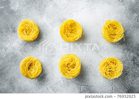 Angel hair pasta, on gray stone background, top view flat lay 76932025