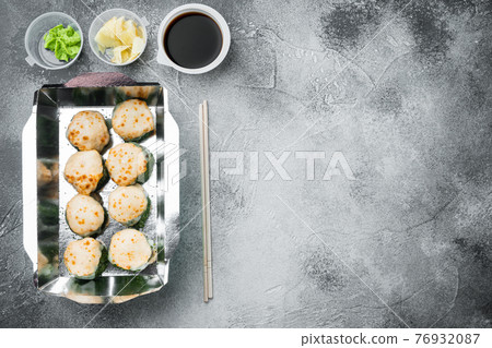Variety of different sushi and rolls fro, salmon and tuna in delivery food concept, on gray stone background, top view flat lay , with copyspace and space for text 76932087