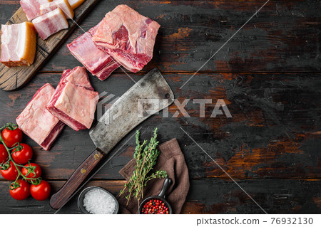 Raw beef ribs kalbi, with ingredients , and old butcher cleaver knife, on old dark wooden table background, top view flat lay, with copy space for text 76932130