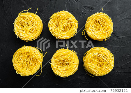 Angel hair pasta, on black stone background, top view flat lay Angel hair pasta, on black stone background, top view flat lay 76932131