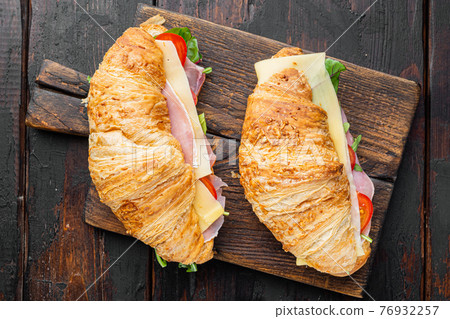 Classic BLT croissant sandwiches, on old dark wooden table background, top view flat lay Classic BLT croissant sandwiches, on old dark wooden table background, top view flat lay 76932257