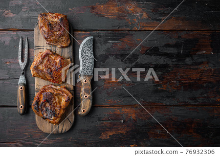 Homemade Braised Beef Short Ribs, on old dark wooden table background, top view flat lay, with copy space for text 76932306