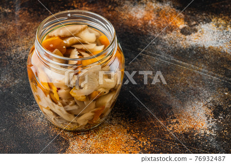 Marinated mushrooms, on old dark rustic background , with space for text copyspace 76932487