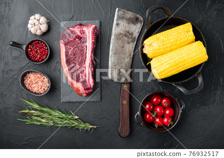 Raw fresh marbled meat black angus club steak and ingredients, on black stone background, top view flat lay Raw fresh marbled meat black angus club steak and ingredients, on black stone background, top view flat lay 76932517