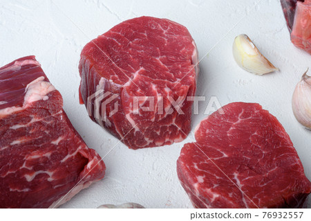 Raw fresh marbled meat Steak filet mignon , on white stone surface 76932557