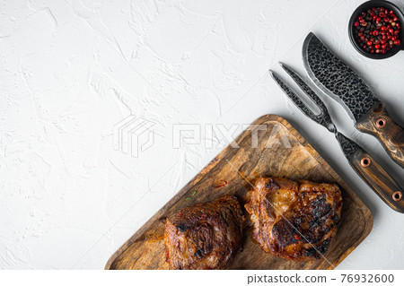 Baked short beef ribs , on white stone background, top view flat lay, with copy space for text 76932600