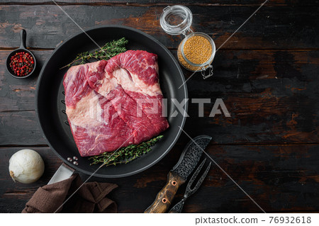 Fresh uncooked raw meat beef brisket, on old dark wooden table background, top view flat lay, with copy space for text Fresh uncooked raw meat beef brisket, on old dark wooden table background, top view flat lay, with copy space for text 76932618