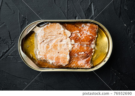 Canned Smoked Trout Fillets, in tin can, on black background, top view flat lay Canned Smoked Trout Fillets, in tin can, on black background, top view flat lay 76932690