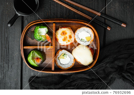 Bento sushi roll, on black wooden table background, top view flat lay Bento sushi roll, on black wooden table background, top view flat lay 76932696