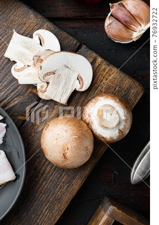 Brown champignons mushroom, on old dark wooden table background, top view flat lay Brown champignons mushroom, on old dark wooden table background, top view flat lay 76932722