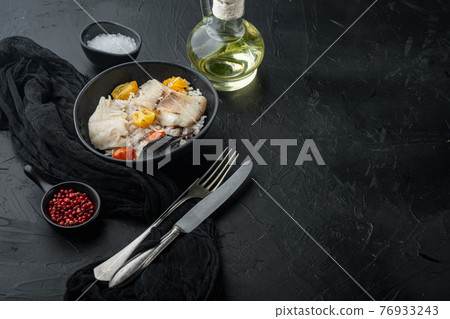 Tilapia fish with basmati rice and cherry tomatoes in bowl, on black background with copy space for text Tilapia fish with basmati rice and cherry tomatoes in bowl, on black background with copy space for text 76933243