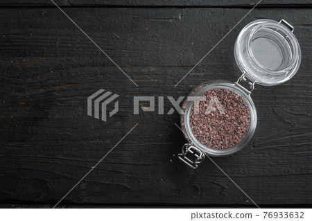 Indian Black salt, Kala namak hindi Healthy food concept, in glass jar, on black wooden background, top view flat lay , with copyspace and space for text Indian Black salt, Kala namak hindi Healthy food concept, in glass jar, on black wooden background, top view flat lay , with copyspace and space for text 76933632