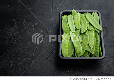 Organic Green Sugar Snap Peas Ready to Eat, in plastic container, on black stone background , with copyspace and space for text Organic Green Sugar Snap Peas Ready to Eat, in plastic container, on black stone background , with copyspace and space for text 76933667