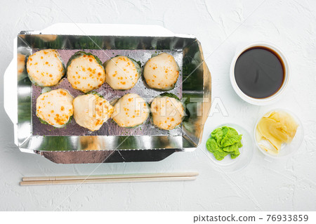 Variety of different sushi and rolls fro, salmon and tuna in delivery food concept, on white stone background, top view flat lay 76933859
