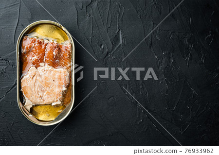Wild Pink Salmon Canned smoked fish, in tin can, on black background, top view flat lay, with copyspace and space for text Wild Pink Salmon Canned smoked fish, in tin can, on black background, top view flat lay, with copyspace and space for text 76933962