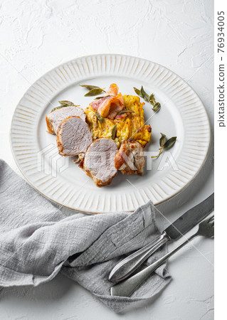 Grilled pork fillet and mash potatoe gratin with sage and prosciutto , on plate dish, on white stone background Grilled pork fillet and mash potatoe gratin with sage and prosciutto , on plate dish, on white stone background 76934005