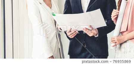 Businessman and businesswomen working in office. 76935869