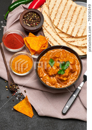 Plate of Traditional Chicken Curry and rice on dark concrete background 76936849