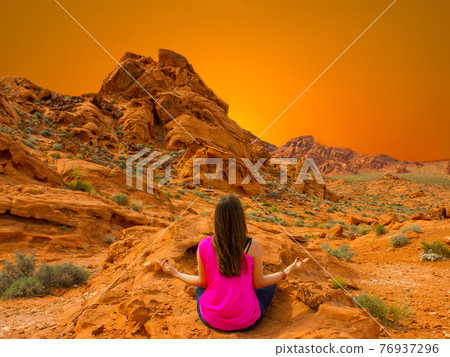 Young woman meditating outdoors Young woman meditating outdoors 76937296