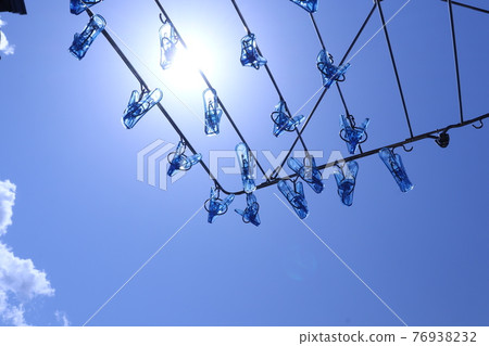 Blue sky, sun, pinch hanger (image of washing) Blue sky, sun, pinch hanger (image of washing) 76938232
