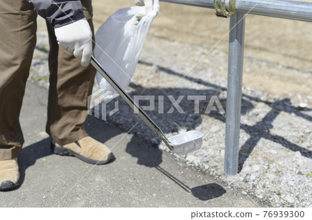 Senior man picking up trash (without face) 76939300
