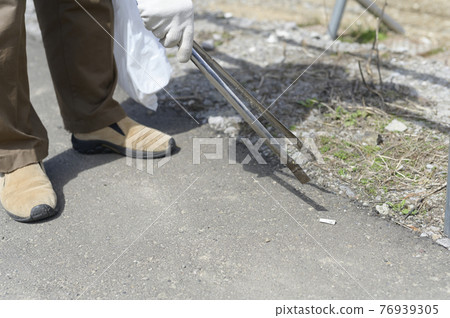 Senior man picking up butts (without face) 76939305