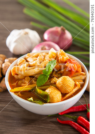 Tom yam kong or Tom yam is a spicy clear soup typical in Thailand and No.1 Thai Dish Cuisine. Thai food. 76940191