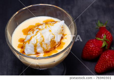 Snowy eggs and custard recipe on black background Snowy eggs and custard recipe on black background 76940301