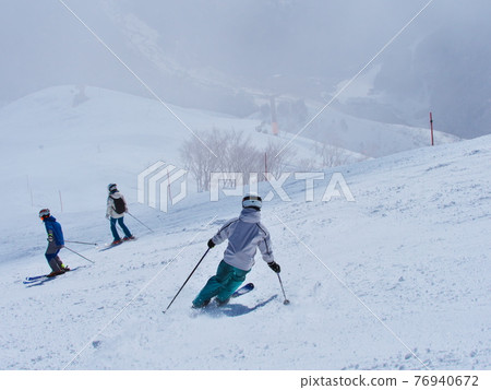 Hakuba Happoone Ski Resort Observation Course Skiers skiing in light fog Hakuba Happoone Ski Resort Observation Course Skiers skiing in light fog 76940672