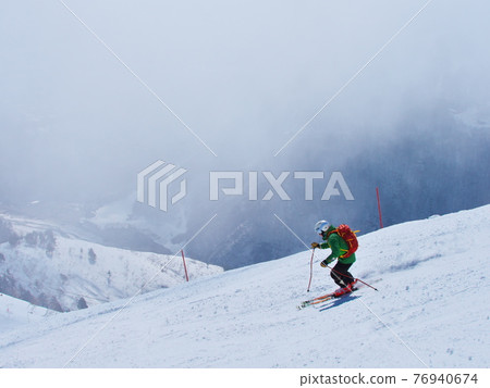 Hakuba Happoone Ski Resort Observation Course Skiers skiing in light fog Hakuba Happoone Ski Resort Observation Course Skiers skiing in light fog 76940674
