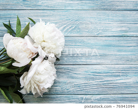 Peony flowers on a blue wooden background Peony flowers on a blue wooden background 76941094