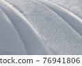 Traces from the car on a snowy road. 76941806