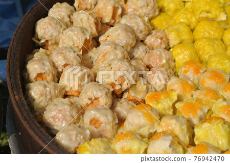 Dim Sum with miscellaneous taste in wooden steam cooker. Dim Sum is one of the famous Chinese food. It is cooked by steam at a high temperature.  76942470